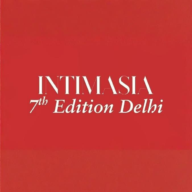 People browsing clothing at exhibition booth